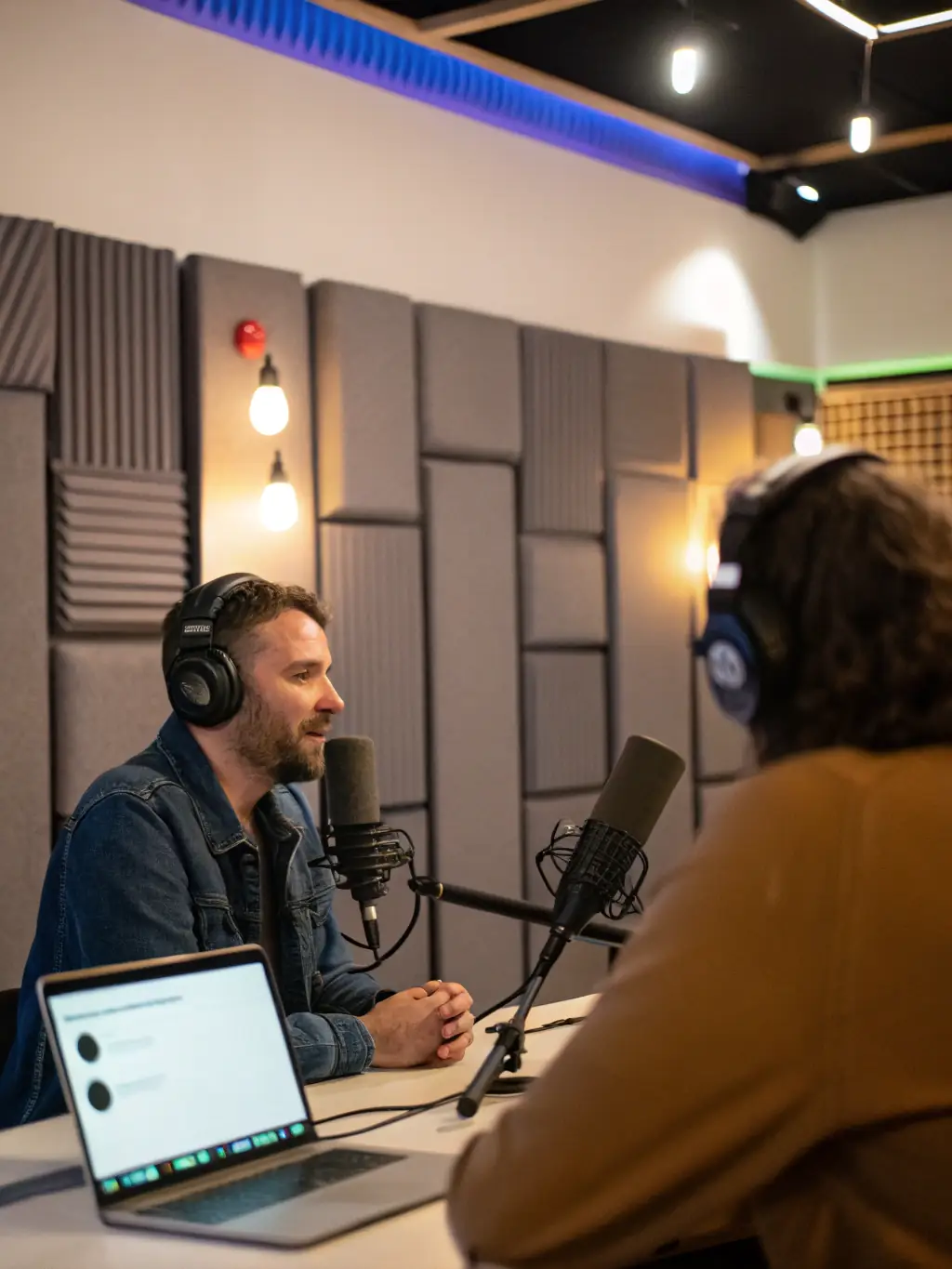A diverse group of professionals are attending a DrHeyStudios workshop on podcasting, learning about audio recording, editing, and distribution techniques.